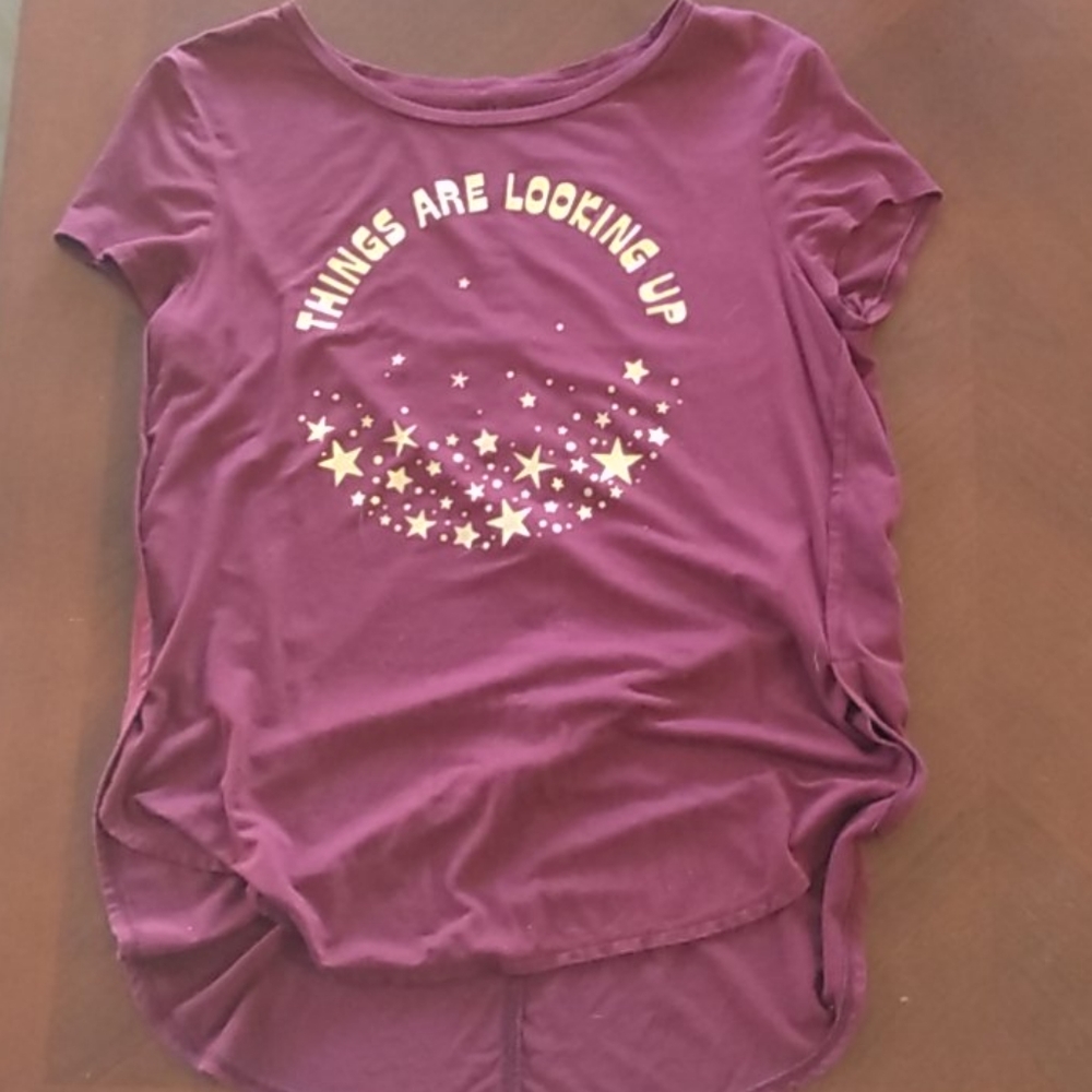 A short sleeve maroon shirt with a long back